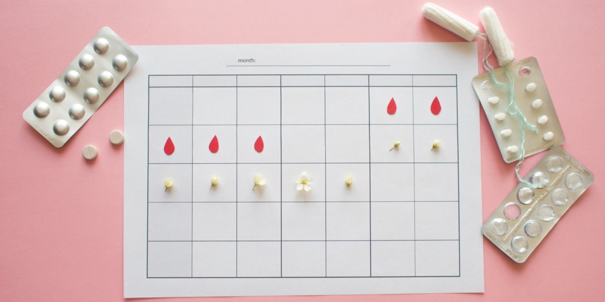 period tracker, oral contraceptive pill, tampons and pink background